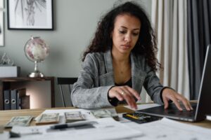Professional woman reviewing a job offer letter and salary breakup document at her desk