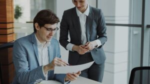 Two professionals discussing a performance improvement plan document in an office — PIP India 2026