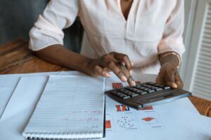 Professional woman calculating gratuity at a desk with financial documents — India 2026 salary guide