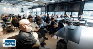 Best Corporate Training India UAE-Based Companies - a diverse group of professionals attentively listening during an indoor