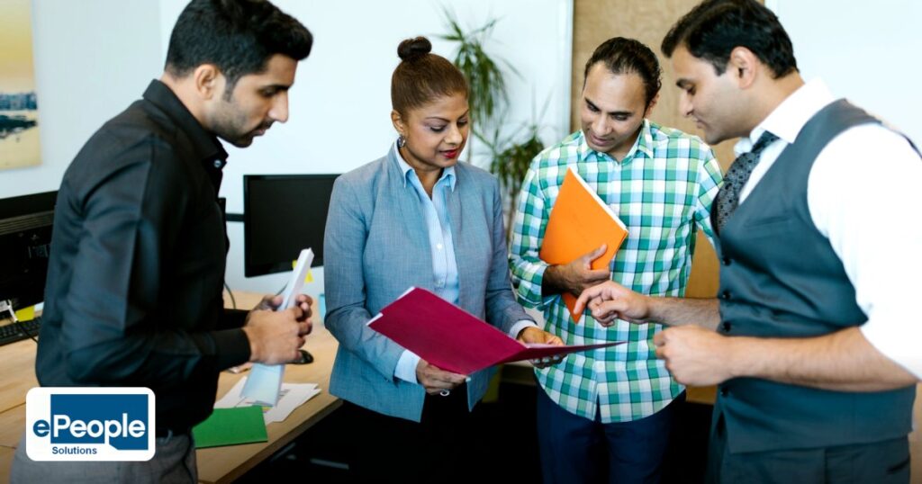 Contractor Workforce Compliance UAE – Indian Staffing Agencies - business team engaged in discussion during a meeting