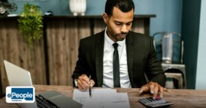 Blue Collar Hiring India Process: Screening Basics - a focused businessman works with a calculator and documents in a modern