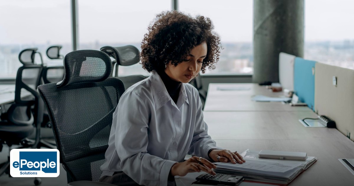 Campus Hiring Hyderabad Employers: Plan a Drive - a professional woman with curly hair calculating documents in a modern