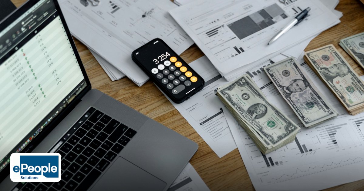 Fixed Term Employment vs Contract Staffing India 2026 - a desk with financial documents, currency, a laptop, and phone