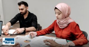GCC Recruitment Strategies India: Building Pipelines - a multicultural office group analyzing documents and charts during