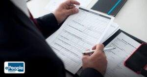 RPO Pricing Models India 2026: A Strategic Guide - a businessman in a black suit reviews a printed application form