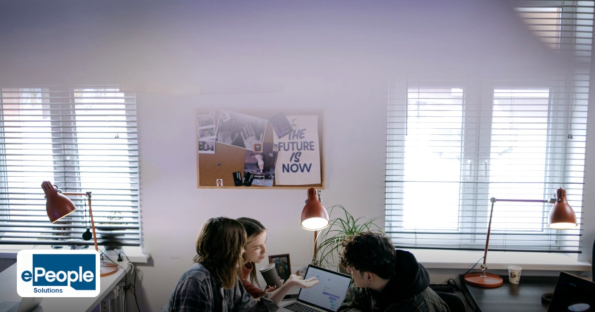 Should we choose online or classroom training for our employees - a group of people discussing ideas around laptops